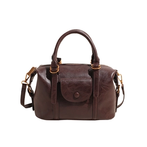 Classic dark brown Boston pillow bag with front pocket and adjustable shoulder strap