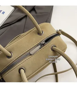 Close-up of smooth metal zipper and premium khaki matte leather on a luxury handbag