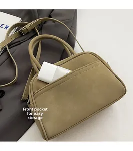 Close-up of olive green bowling bag featuring a front pocket and matte textured finish
