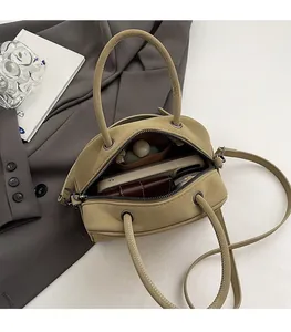 Interior view of olive green bowling bag showing spacious capacity for phone and wallet