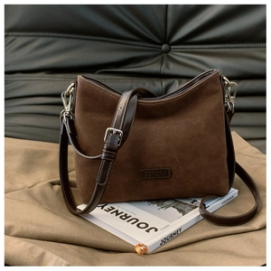 Detail der braunen Wildleder-Schultertasche mit verstellbarem Riemen und Logo