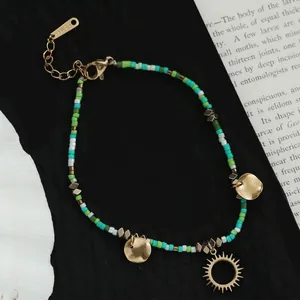 Bohemian multicolored beaded bracelet with golden sun pendant and adjustable lobster clasp