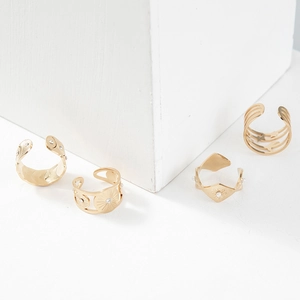 Detailed view of 14K gold-plated open rings with sunburst and starburst zircon patterns