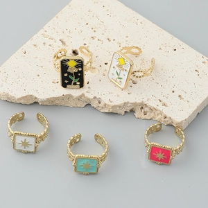 Five assorted vintage enamel open rings in gold finish with star and tarot motifs