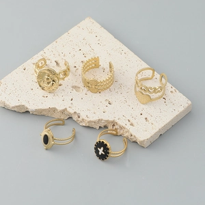 5-piece set of gold-plated stainless steel rings featuring black enamel and portrait designs