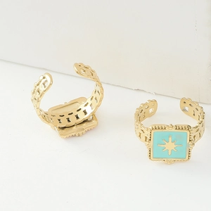 Close-up of vintage 14K gold-plated ring featuring blue enamel and star engraving detail