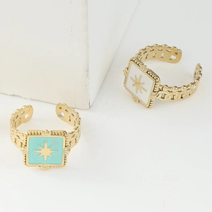 Detail of gold open rings with blue and white enamel star motifs and hollow chain bands
