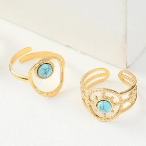Detailed view of two gold turquoise open rings with vintage bohemian engraved patterns