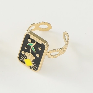 Detailed macro of gold adjustable ring with black enamel tarot sun and star pattern