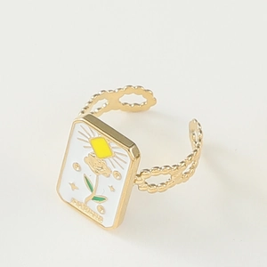 Detail of white enamel Tarot Sun ring with golden wavy band and adjustable opening