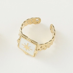 Detail of vintage 14K gold open ring with square white enamel and sunburst star motif