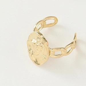 Detail of vintage 14K gold plated open ring featuring an oval relief and Cuban link band