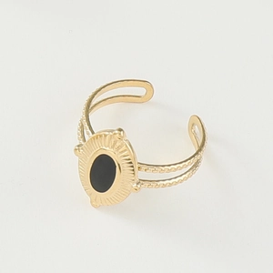 Detail of 14K gold plated ring with black enamel center and sunburst engraving