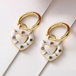 Detailed shot of 18K gold heart earrings with white enamel and colorful micro-zirconia stones