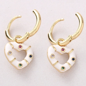Detailed view of 18K gold heart earrings with white enamel and colorful crystals