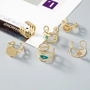 Set of bohemian gold open rings featuring sun, moon, and evil eye details with crystals