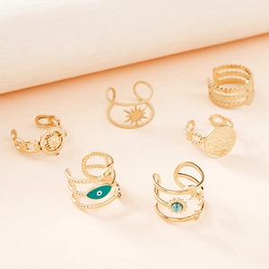 Detailed view of bohemian 6-piece gold evil eye and turquoise stackable ring set