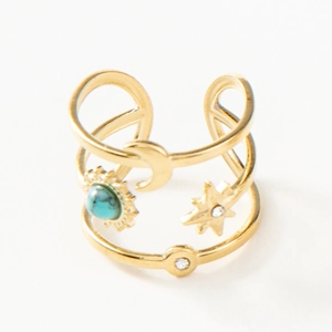 Detail of bohemian gold ring featuring celestial motifs with turquoise and zircon stones