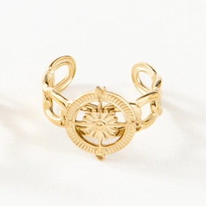 Detailed view of golden compass star open ring with Cuban link band design