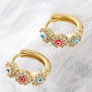 Gold evil eye hoop earrings with micro paved blue and pink crystals in round discs