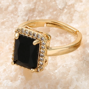 Macro shot of a vintage gold adjustable ring with a square black zircon and micro-pave halo