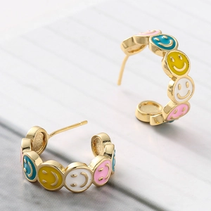 Gold-plated C-shaped hoop earrings featuring colorful enamel smiley faces for women