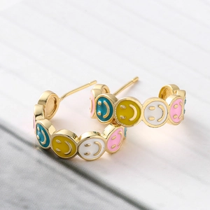 Golden C-shaped stud earrings with colorful enamel smiley faces in vibrant pop style