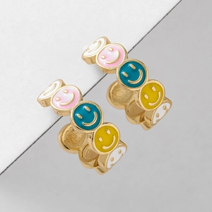 Colorful enamel smiley face hoop earrings in gold metal on a minimalist geometric background