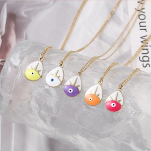 Detail of colorful water-drop evil eye pendants in five enamel colors with gold chains