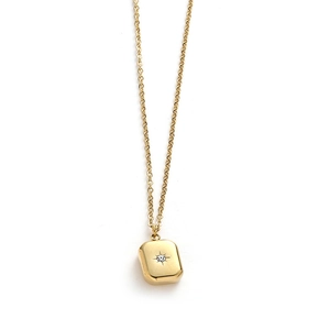 Detail of gold necklace featuring a rectangular pendant with starburst and crystal inlay