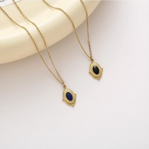 Vintage gold oval pendant necklace set with deep blue and black enamel details