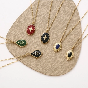 Detail of 6-piece 14K gold plated necklaces featuring oil-drop cross and snake pendants