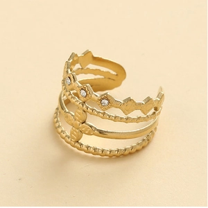 Detail of gold multi-layer cutout ring featuring cross floral patterns and crystal inlay