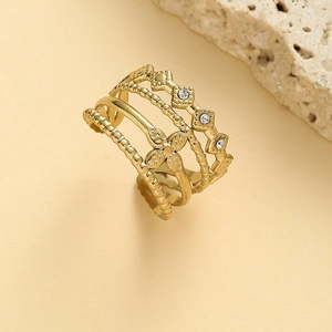 Bohemian gold layered open ring featuring hollow floral design and crystals on rock