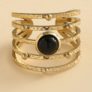 Hammered gold layered ring featuring five bands and a centered round black gemstone inlay