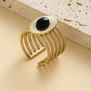Vintage golden wide open ring with oval black stone and sunburst textured pattern