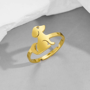 Detailed close-up of a minimalist golden dog silhouette ring with adjustable open band