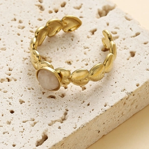Golden stainless steel heart-shaped ring with a pink zircon stone on stone stand