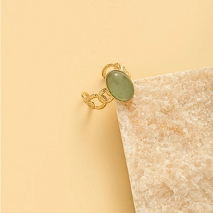 Vintage gold adjustable open ring featuring oval green gemstone and woven texture