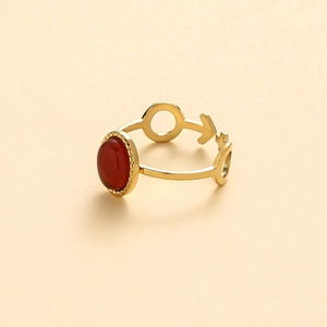 Detail of red oval natural stone ring with gold vintage geometric patterns and bead edge