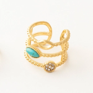 Detailed macro shot of vintage multilayer gold ring with turquoise and rhinestones