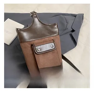 Detail showing the brown suede and polished leather patchwork on a vintage bucket bag