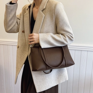 Large dark brown pebble leather tote bag shown with a beige tweed blazer and brown skirt