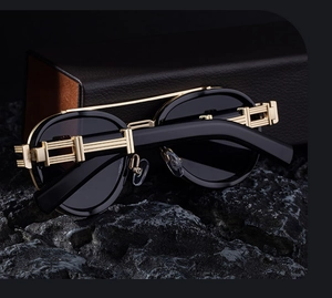 Detail of retro oval sunglasses with industrial gold hollow metal temple hinges