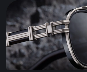 Detailed close-up of premium metal hinge and dual-tone temples on oval sunglasses
