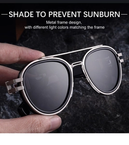 Detail of silver oval metal frame sunglasses with double bridge and hollow temple design