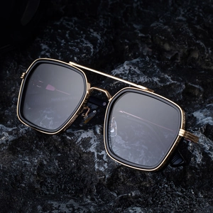 Mens square black and gold double bridge sunglasses on a premium dark rock background