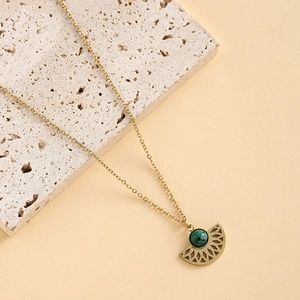 Detail of 14K gold plated necklace with green turquoise stone in a fan-shaped pendant