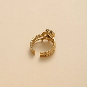 Detail of a 14K gold-plated triple-band ring featuring a textured finish and round inlay