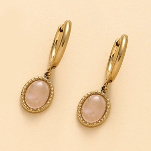 Detailed macro of vintage style 14K gold earrings with pink natural gemstones
